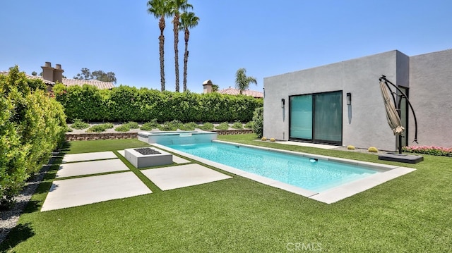 view of pool with a lawn and a patio area