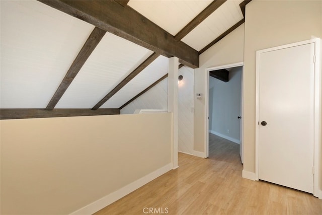 additional living space with light wood-type flooring, beamed ceiling, and high vaulted ceiling