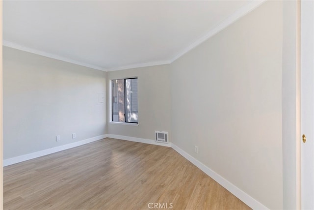 unfurnished room featuring light wood-type flooring and crown molding