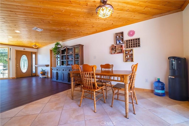 dining space featuring light wood-type flooring, wooden ceiling, and ornamental molding