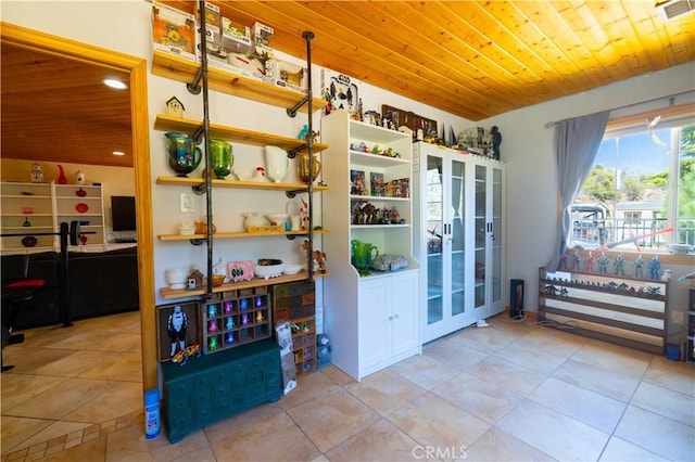 interior space featuring light tile patterned floors and wood ceiling