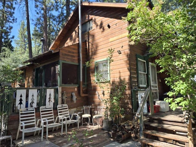 view of property exterior featuring a sunroom