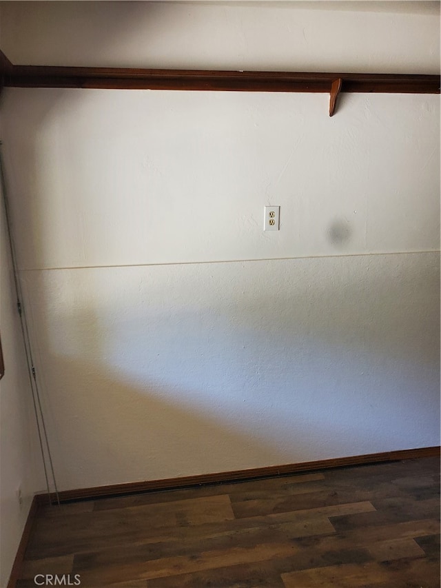 spare room featuring dark hardwood / wood-style flooring