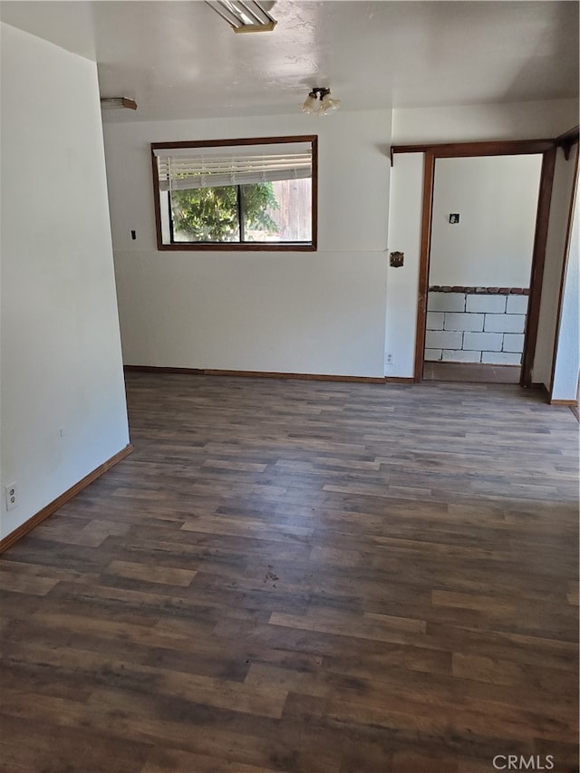 spare room with dark hardwood / wood-style floors