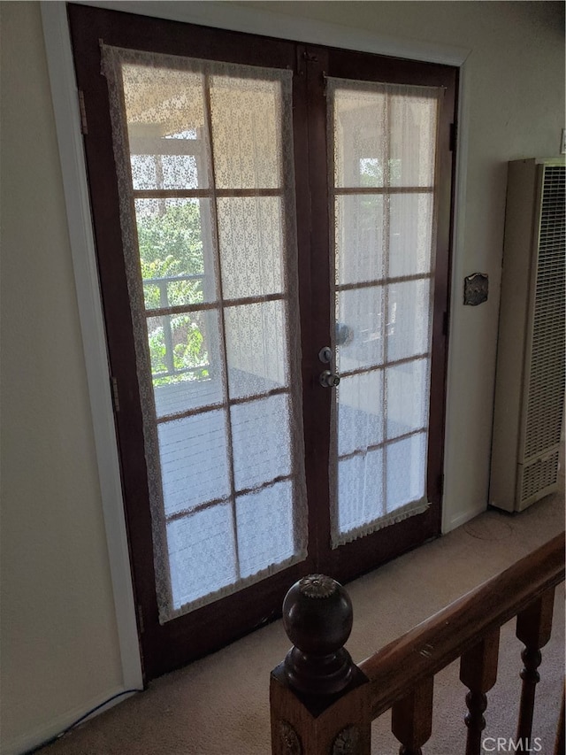 interior details featuring french doors and carpet floors