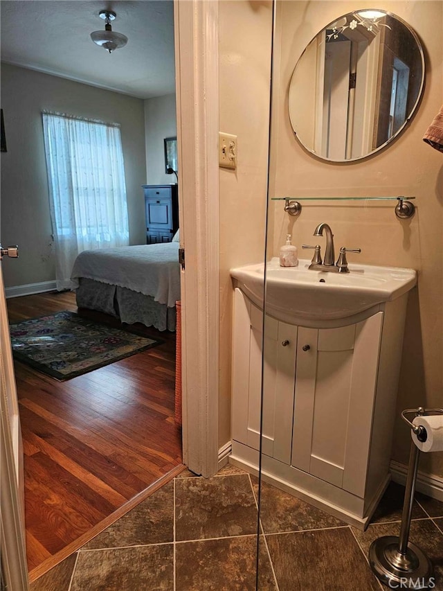 bathroom with hardwood / wood-style floors and vanity