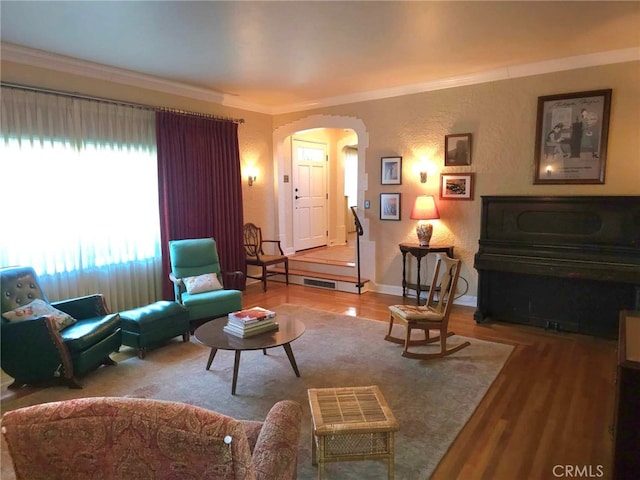 living room featuring hardwood / wood-style flooring and crown molding