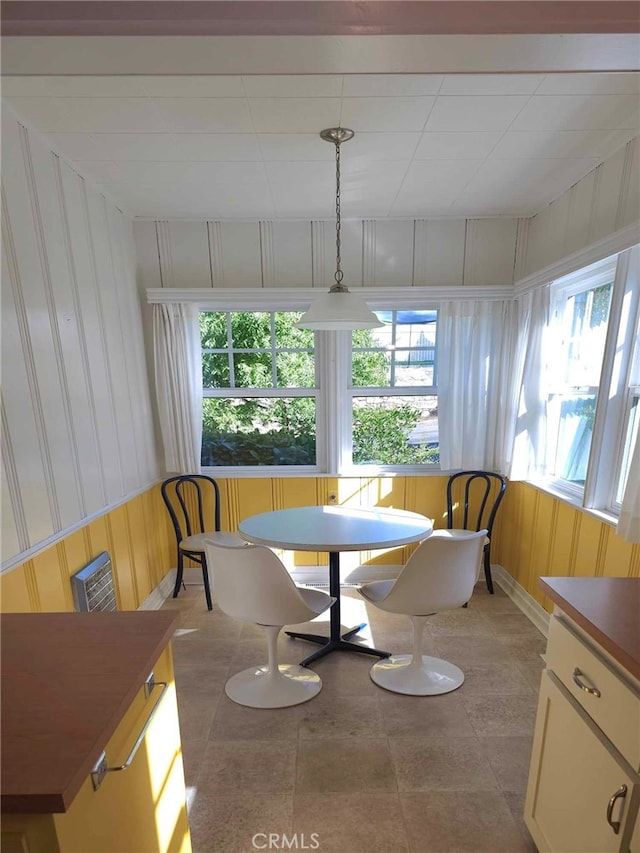 dining room with wood walls