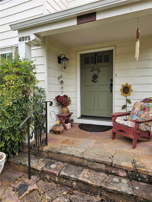 view of exterior entry with covered porch