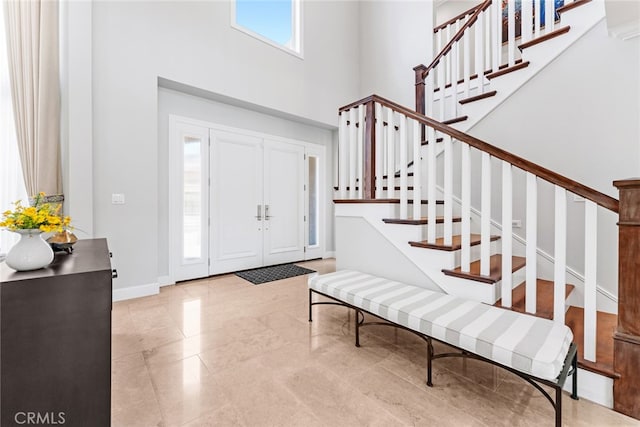 entryway with a towering ceiling