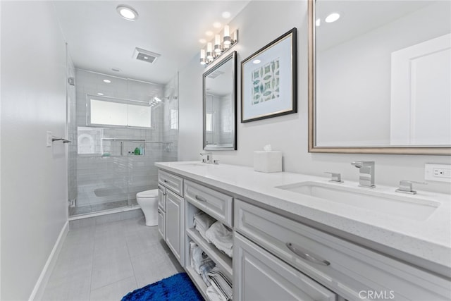 bathroom featuring vanity, toilet, tile patterned flooring, and a shower with door