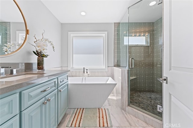 bathroom featuring vanity and shower with separate bathtub