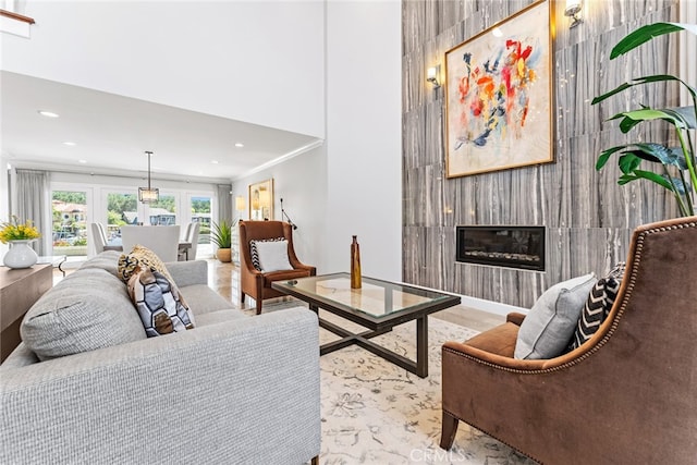 living room featuring crown molding and a fireplace