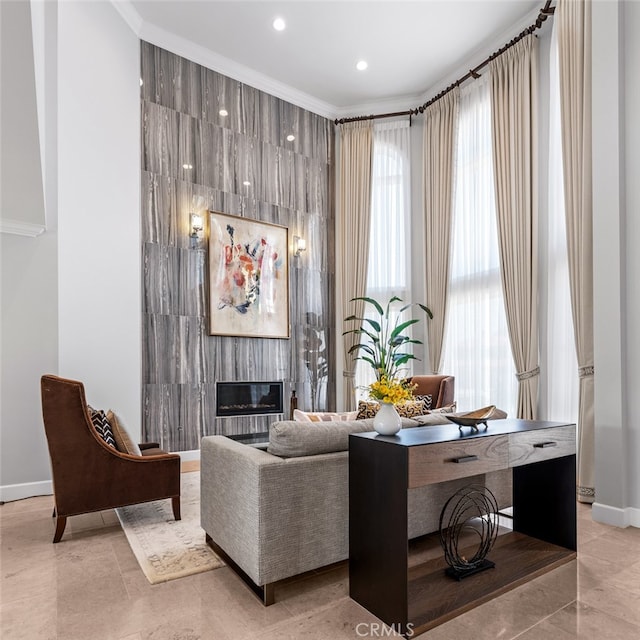 interior space featuring ornamental molding, a healthy amount of sunlight, and a large fireplace