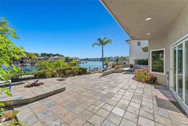 view of patio with a water view