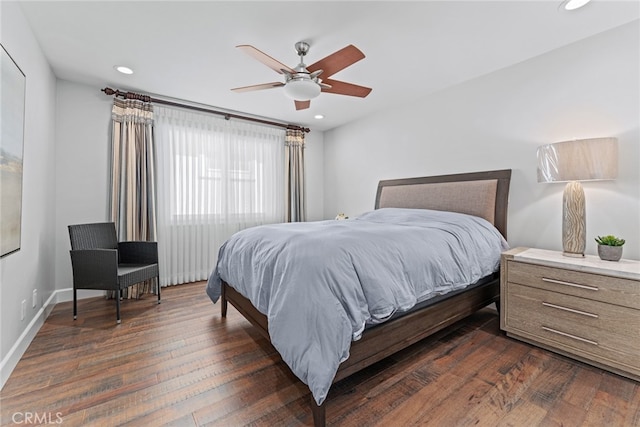 bedroom with dark hardwood / wood-style floors and ceiling fan