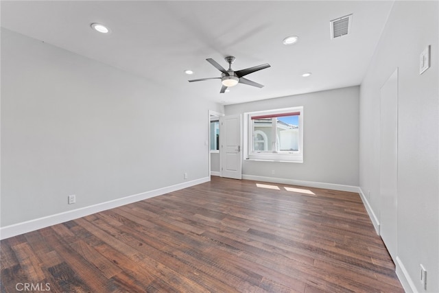 spare room with dark hardwood / wood-style floors and ceiling fan