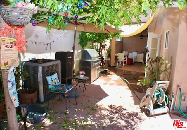 view of patio / terrace with central AC and a grill