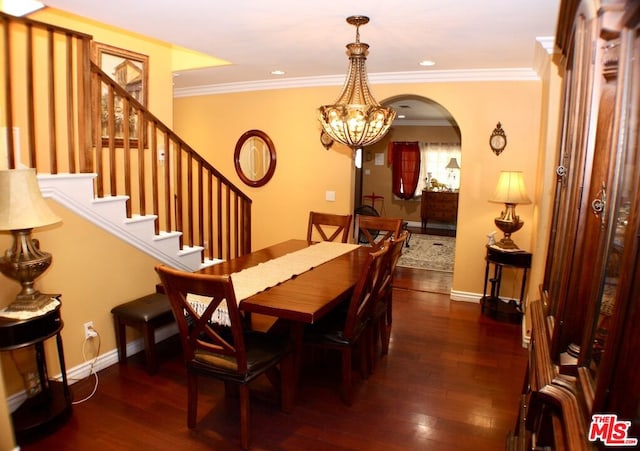 dining area featuring ornamental molding, a chandelier, and dark wood-type flooring