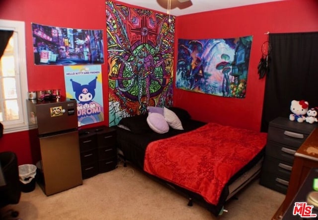 carpeted bedroom with stainless steel refrigerator