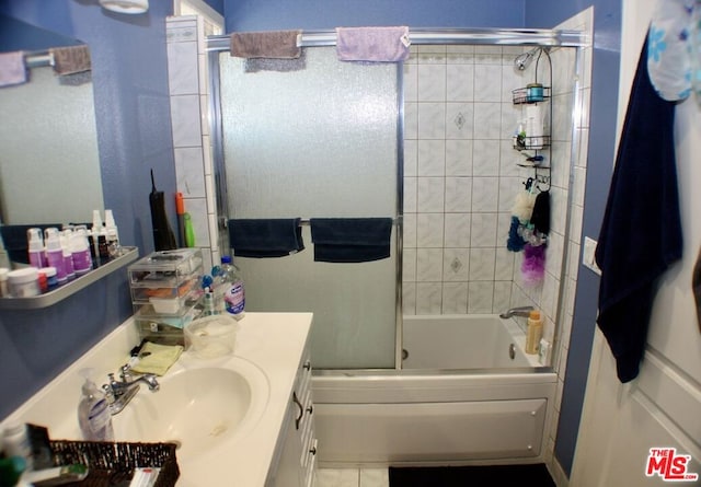 bathroom with bath / shower combo with glass door and vanity