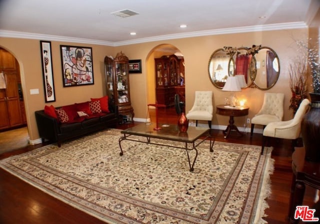 living room with crown molding and hardwood / wood-style flooring