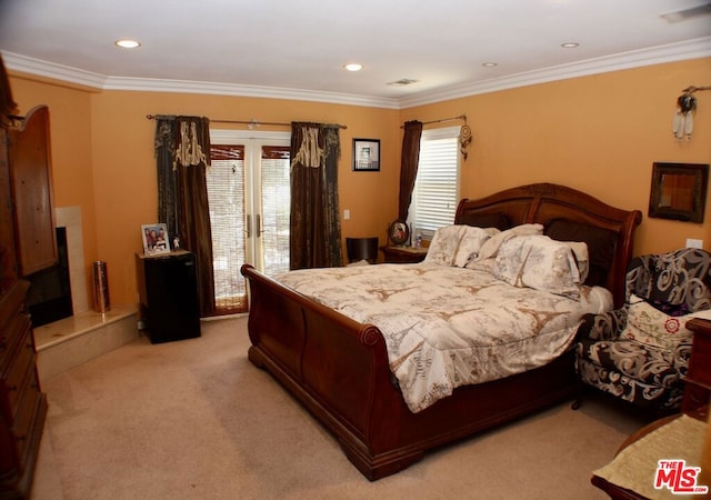 bedroom with ornamental molding, multiple windows, and light colored carpet