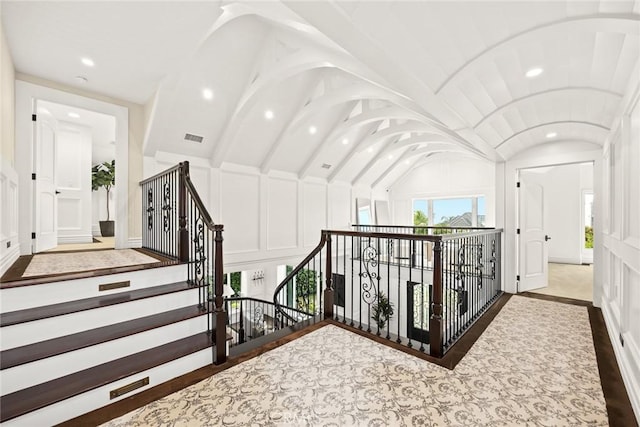 stairway featuring wood-type flooring and lofted ceiling