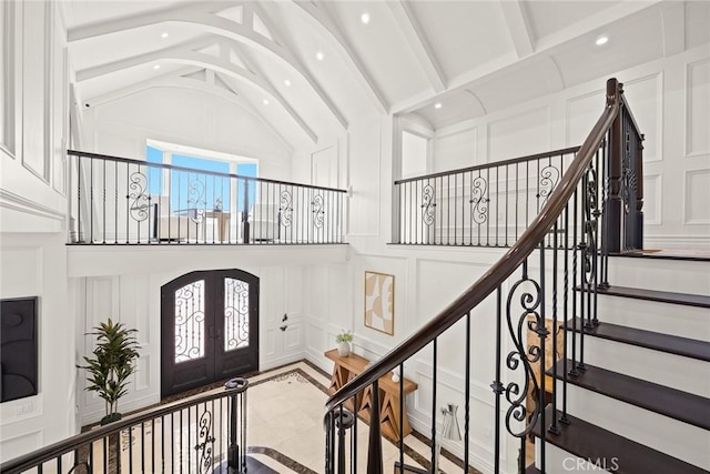 stairs featuring vaulted ceiling with beams and french doors