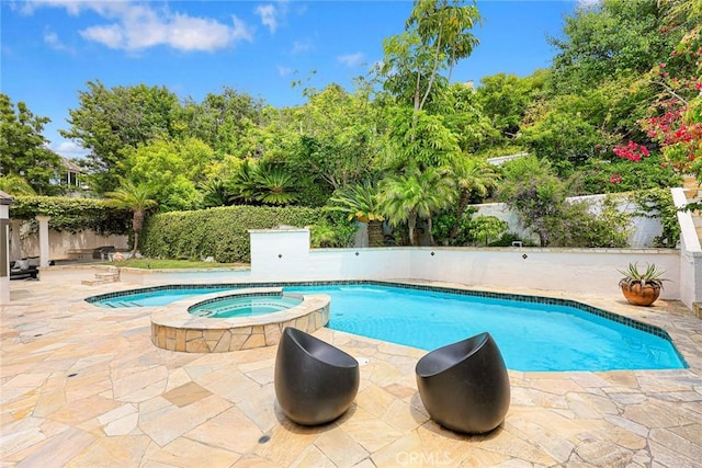 view of pool featuring an in ground hot tub and a patio