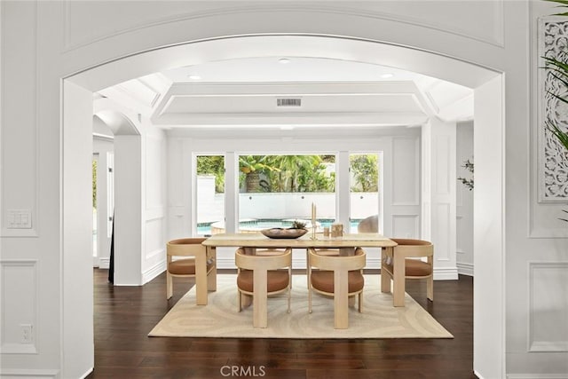 dining area featuring crown molding and dark wood-type flooring