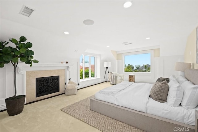 bedroom with light colored carpet and lofted ceiling