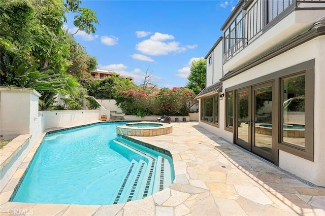 view of pool with a patio area and an in ground hot tub