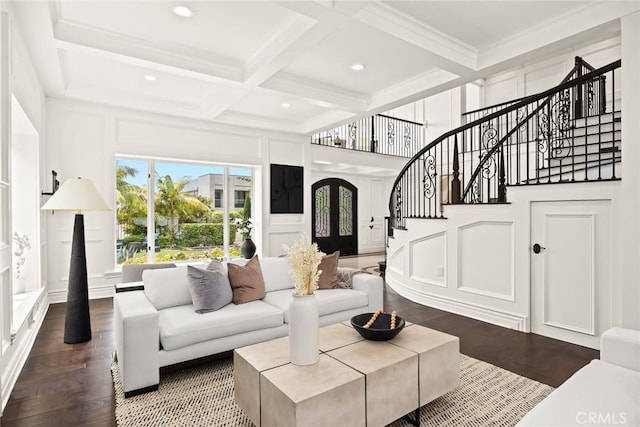 living room with french doors, coffered ceiling, crown molding, beam ceiling, and hardwood / wood-style flooring