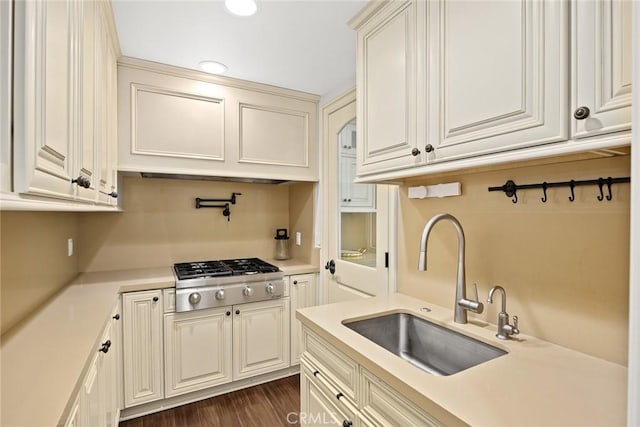 kitchen with stainless steel gas stovetop, dark hardwood / wood-style flooring, and sink