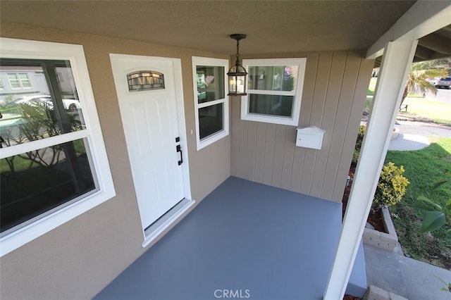 property entrance with covered porch