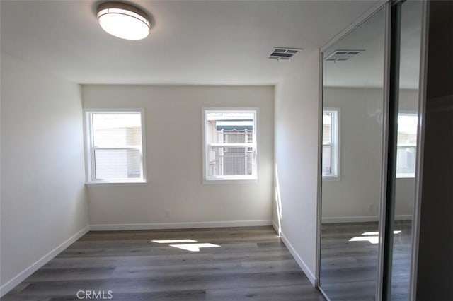 interior space with a closet and dark hardwood / wood-style floors