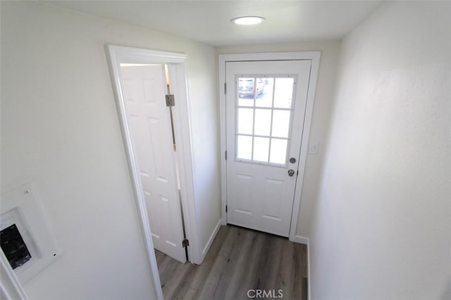 doorway with dark wood-type flooring