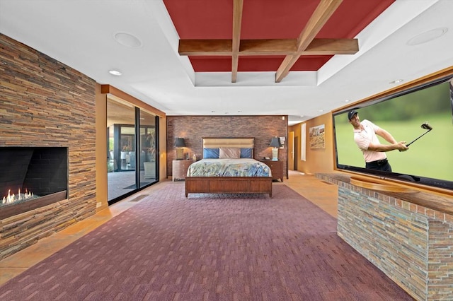 bedroom featuring beam ceiling, access to outside, a stone fireplace, and coffered ceiling