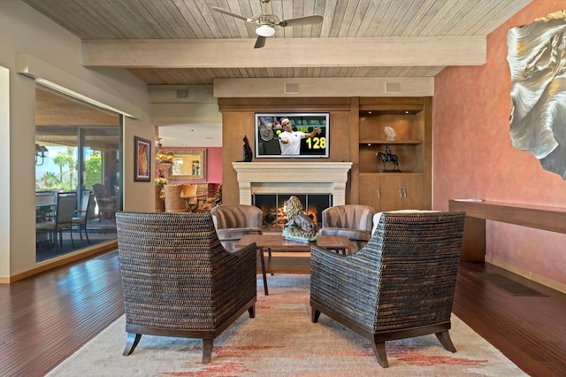 living room featuring beamed ceiling, wood-type flooring, ceiling fan, and wood ceiling