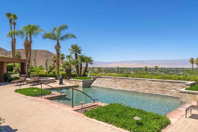 view of pool featuring a mountain view and a patio