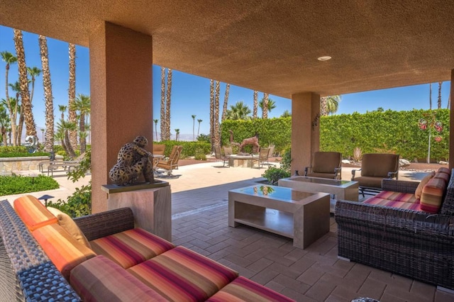 view of patio / terrace with an outdoor living space with a fire pit