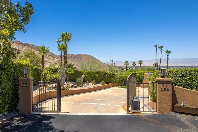 view of gate with a mountain view