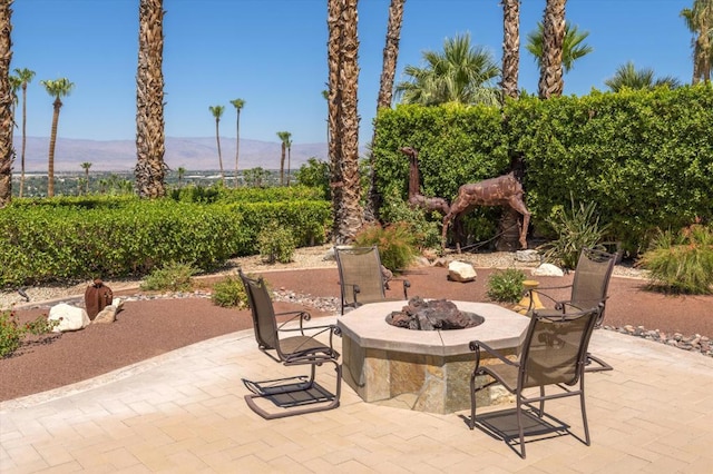 view of patio / terrace featuring a mountain view and an outdoor fire pit