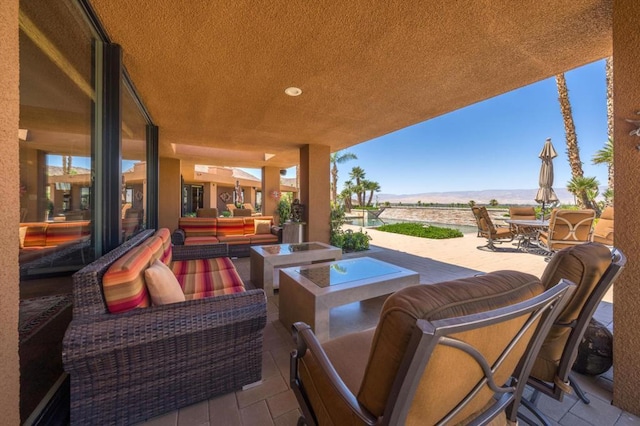 view of patio / terrace featuring an outdoor living space with a fire pit