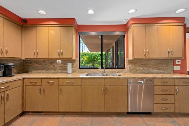 kitchen with stainless steel dishwasher, decorative backsplash, light stone counters, and sink