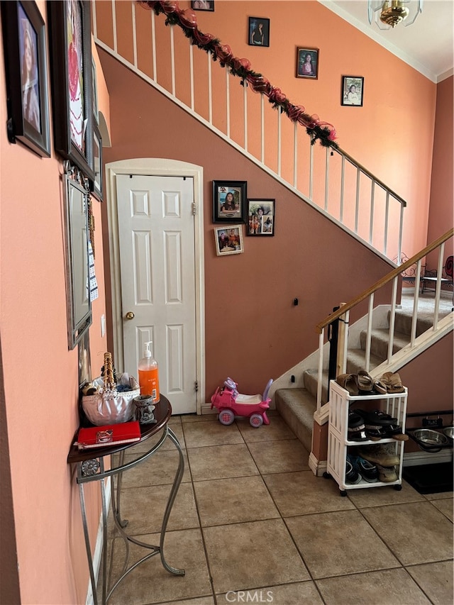 staircase with crown molding and vaulted ceiling