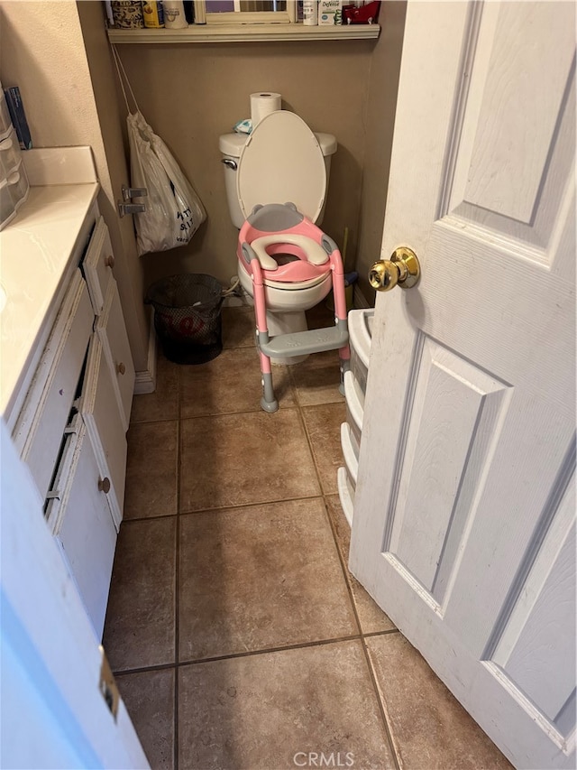 bathroom with vanity, toilet, and tile patterned flooring