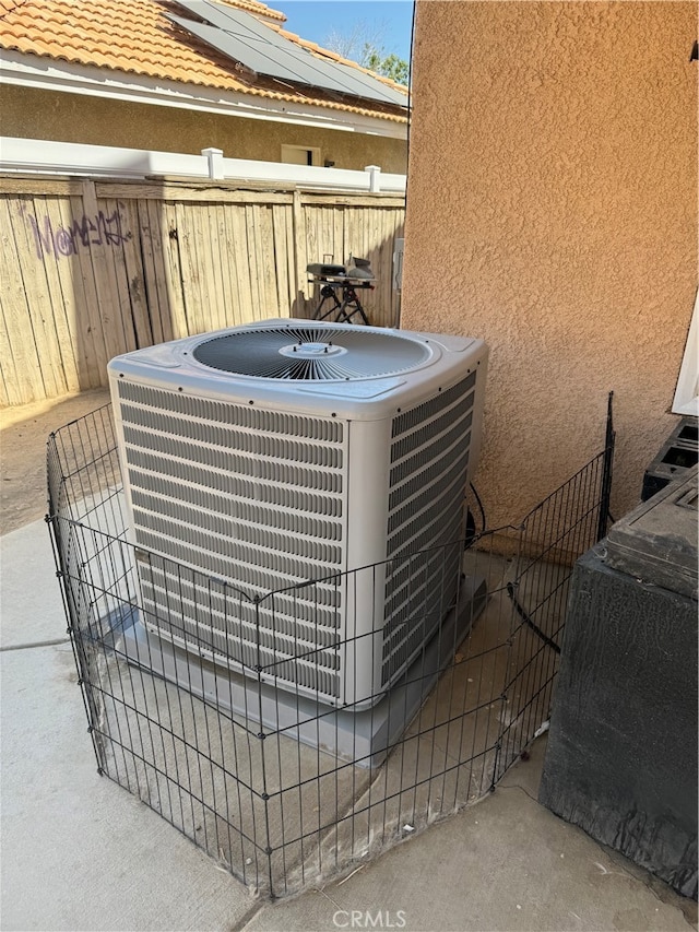 exterior details featuring central air condition unit, concrete floors, and wood walls