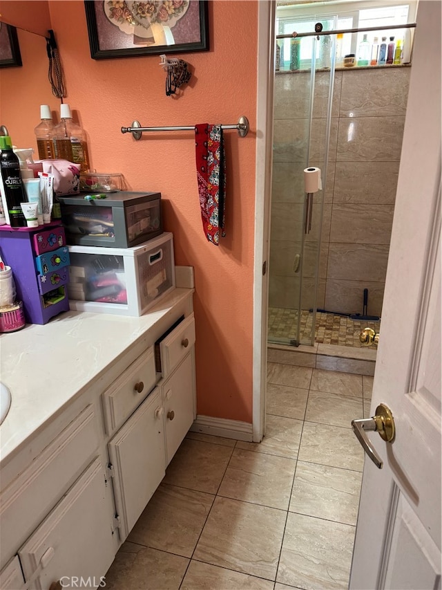 bathroom with vanity, tile patterned floors, and an enclosed shower